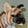 A striped hyena plush toy.